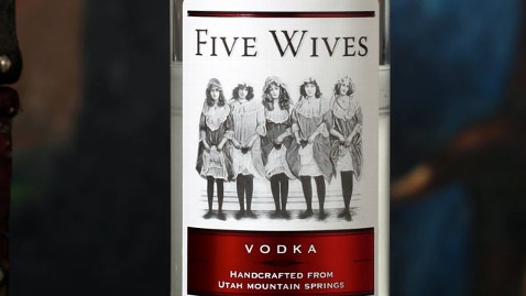 bottle of five wives vodka, there are 5 women holding small cats, dressed from the 1880's