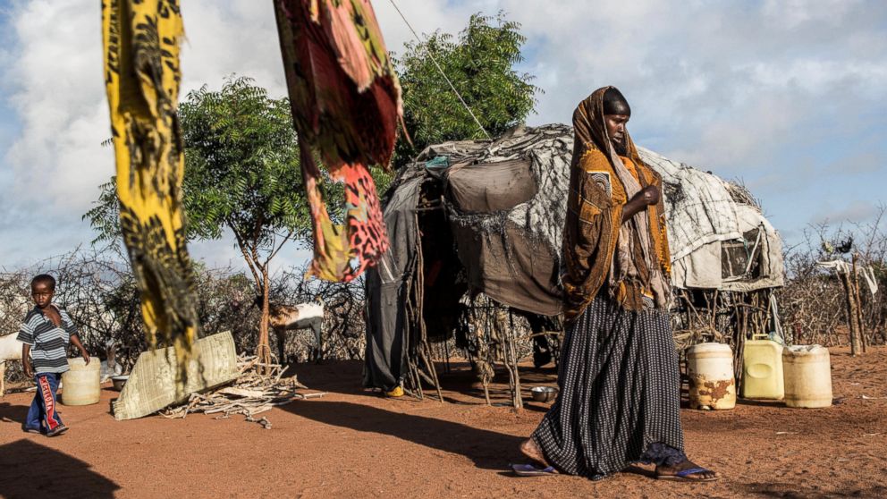 PHOTO: A woman walks through her family's compound in Dadaab refugee camp. Dadaab camp in northeast Kenya is the world's largest refugee settlement, and hosts more than a third of a million Somali refugees.
