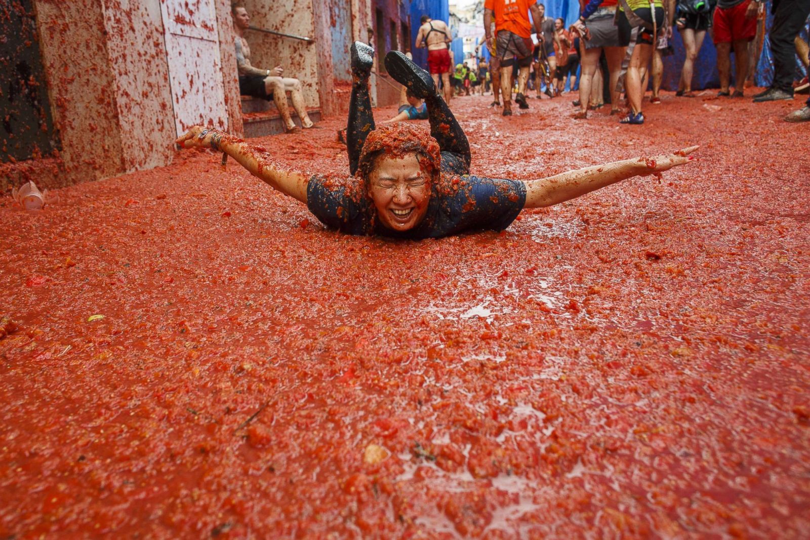 Away they go! Revelers wallow in pulp at Spain's Tomatina Festival
